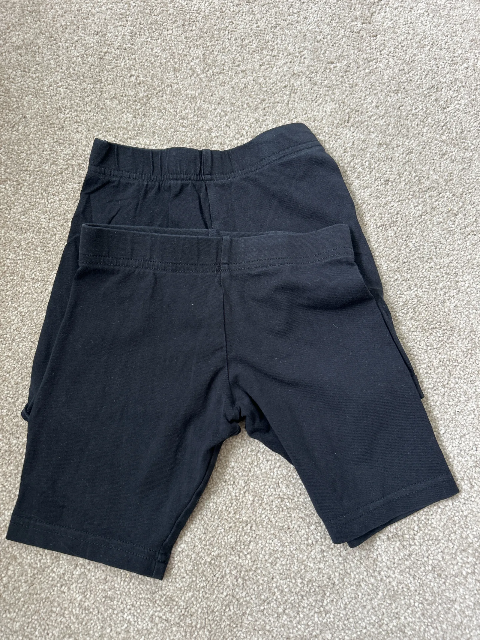 2 girls black mid length shorts