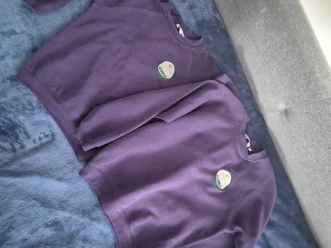 Purple jumper with badge
