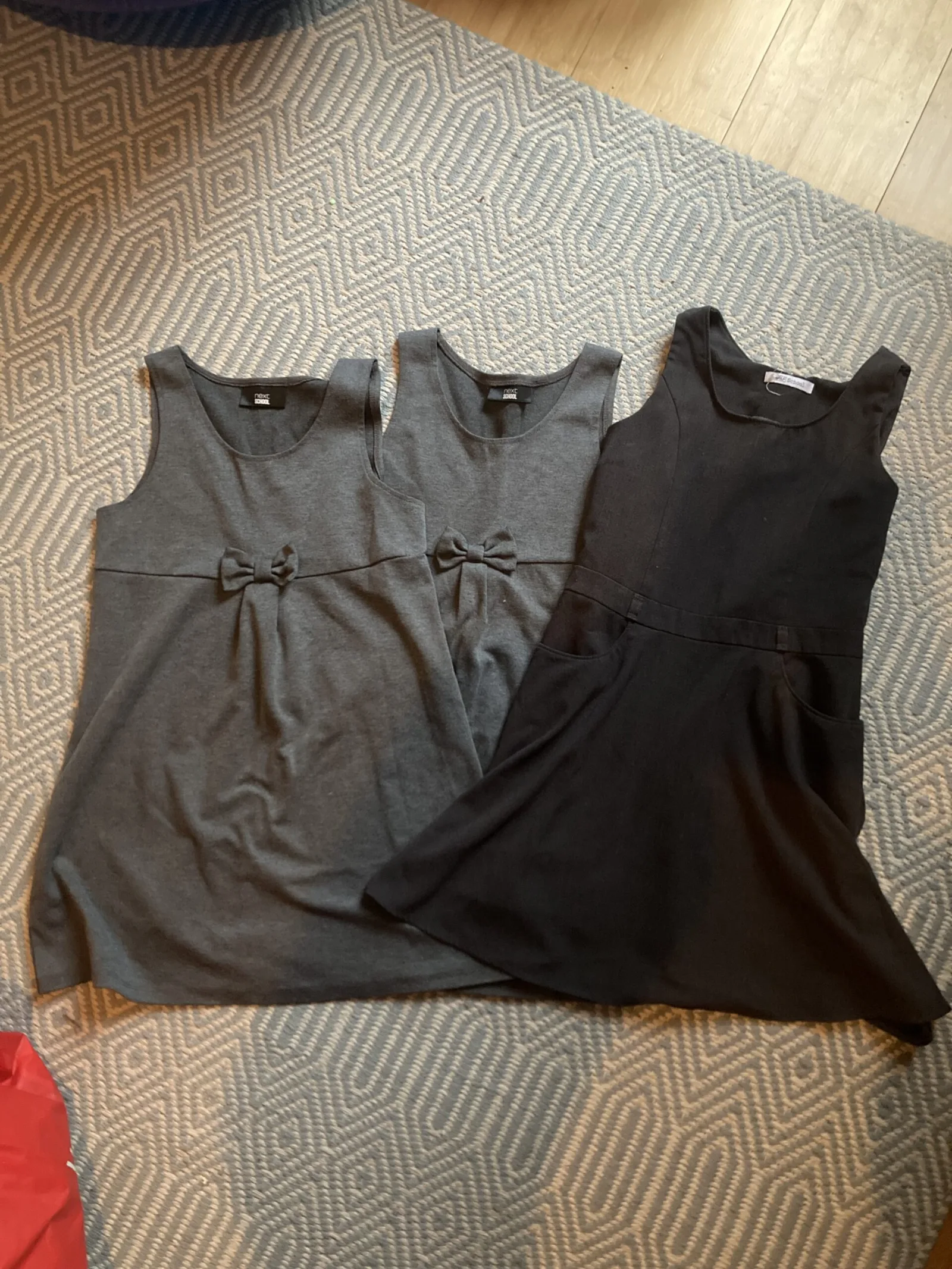 3 grey pinafore dresses. Two from Next age 9, one from Tesco (F&F) age 9-10.